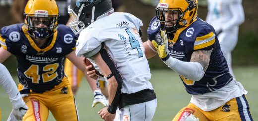 der balltragende Footballspieler wird von zwei Verteidigern angegriffen